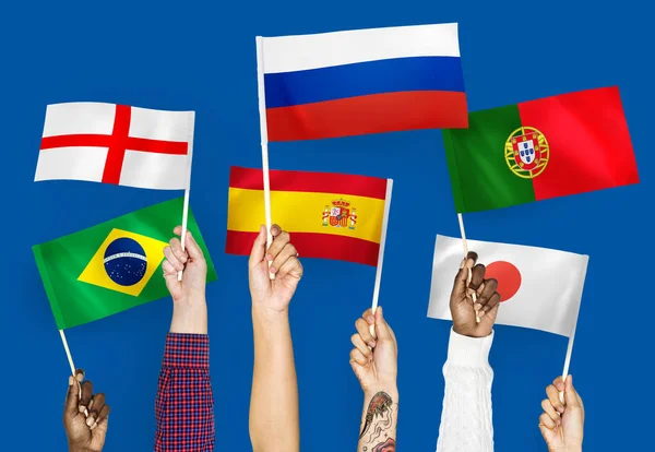 Hands Waving Flags England Spain Japan Portugal Russia Brazil — Stock Photo, Image