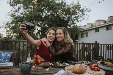 Lesbian couple taking a selfie clipart