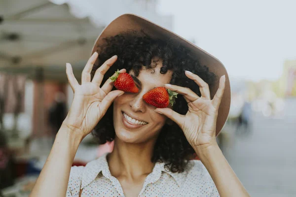 Woman having fun with strawberries