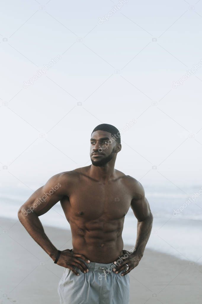 Fit man posing at the beach