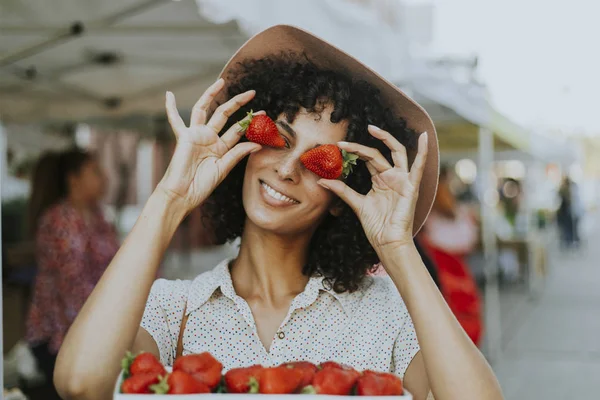 Woman having fun with strawberries