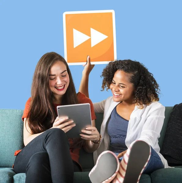 Young Female Friends Holding Fast Forward Icon — Stock Photo, Image