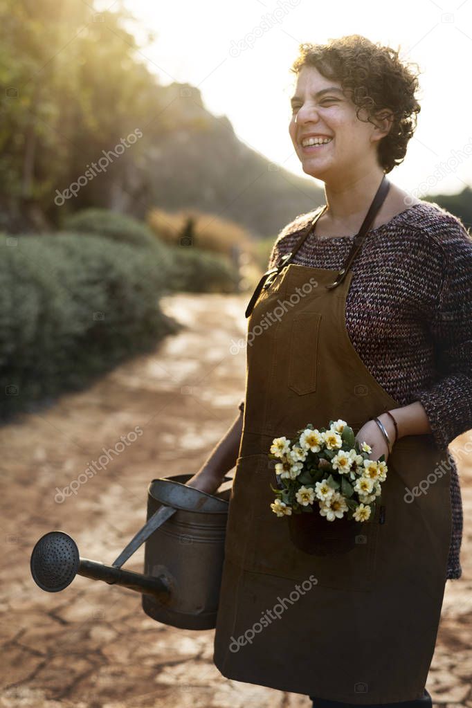 Woman taking care of the flowers at her countryside home