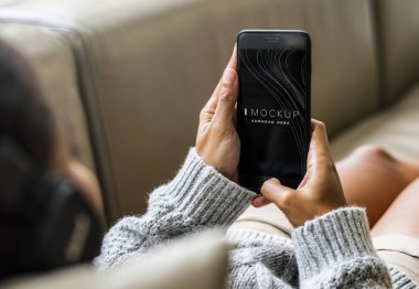 Bir cep telefonu mockup kullanan kadın