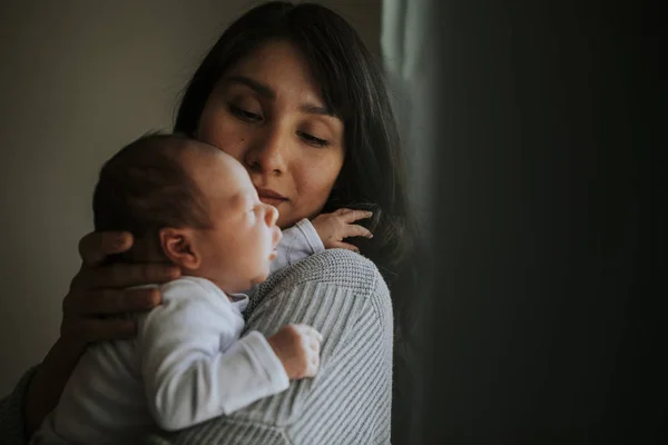 Mother Holding Her Baby Indoors — Stock Photo, Image