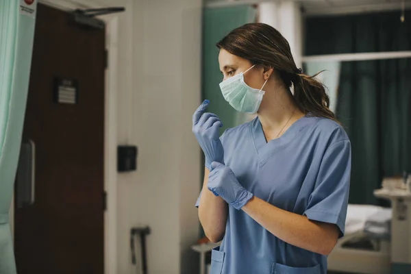 Female Nurse Mask Putting Gloves — Stock Photo, Image