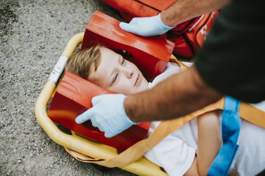 Genç bir ambulans sedyede yatan çocuk yaralandı