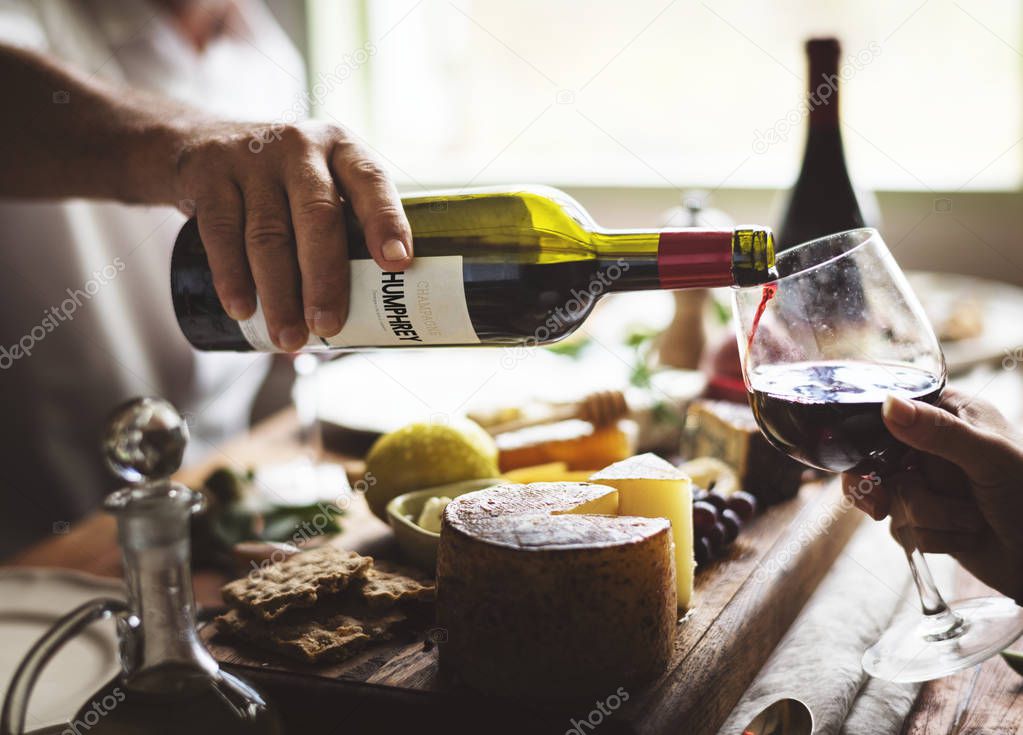 Man pouring red wine into a glass