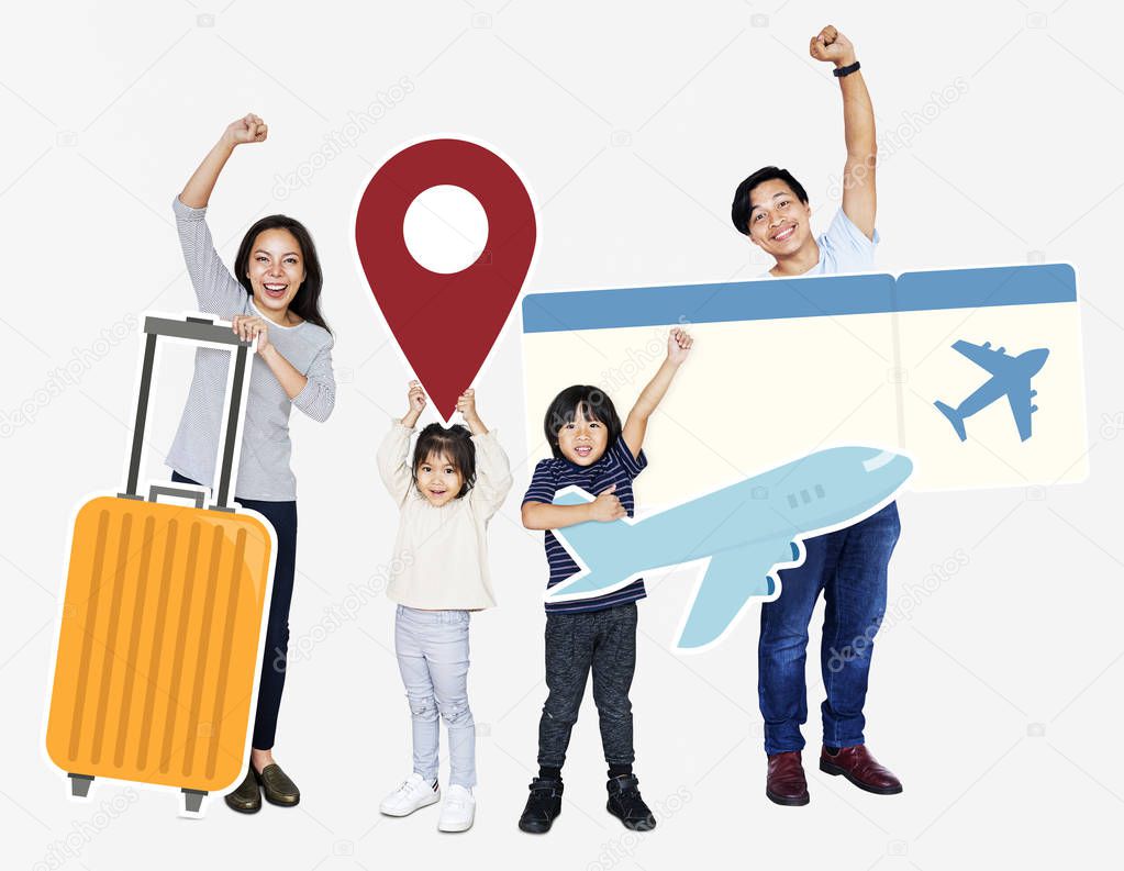 Cheerful family holding travel icons and ticket