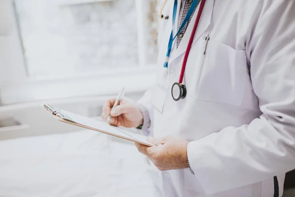 Physician Noting Symptoms Patient — Stock Photo, Image