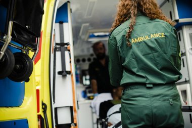 Sağlık görevlileri bir hasta bir ambulansa bir sedyeye taşıma