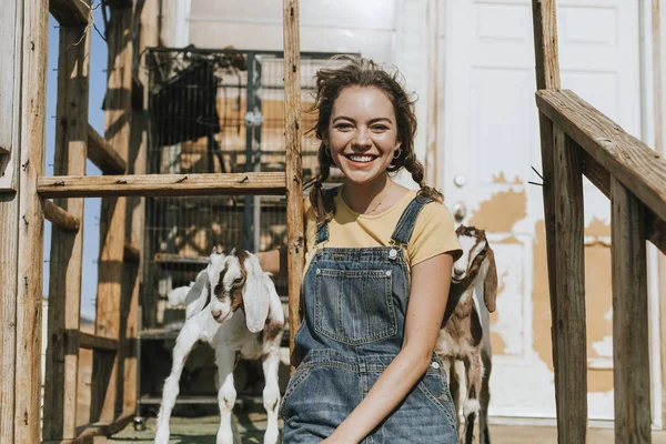 Young Volunteer Feeding Baby Goats — Stock Photo, Image