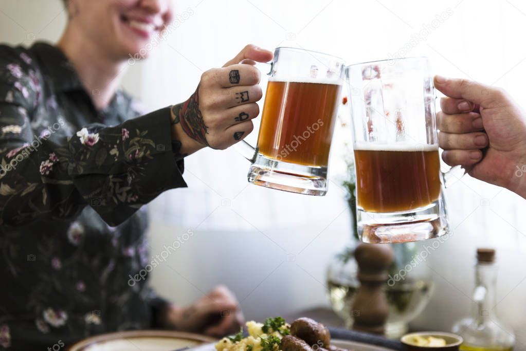Happy women clinking with beer mugs