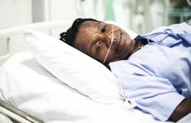 Sick woman in a hospital bed clipart
