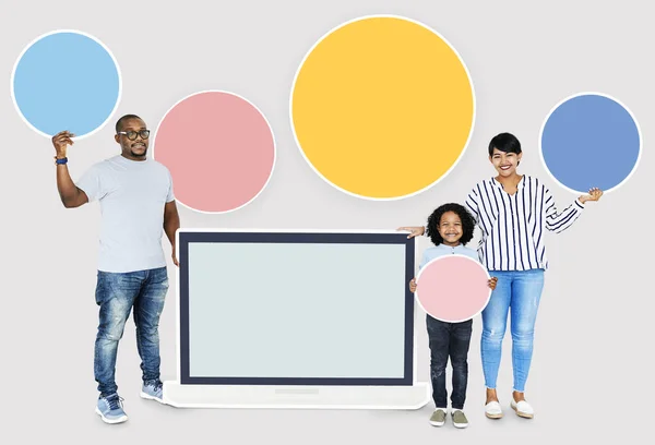 Happy family with a blank laptop screen