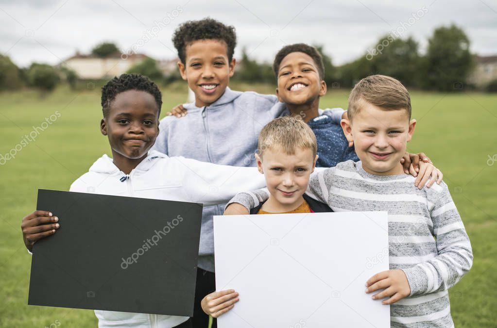 Group of young boys showing blank papers