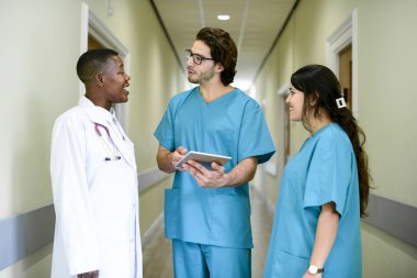 Medical team having a conversation in the hallway clipart