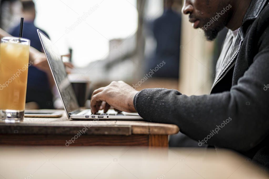 Businessman working remotely from a cafe