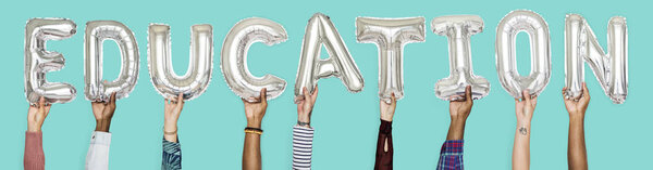 Hands showing education balloons word