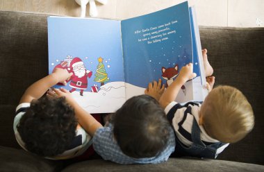 Young kids reading a Christmas story together