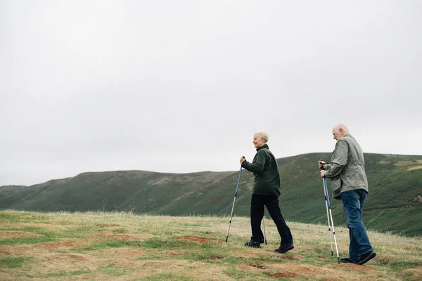 Active seniors with trekking poles