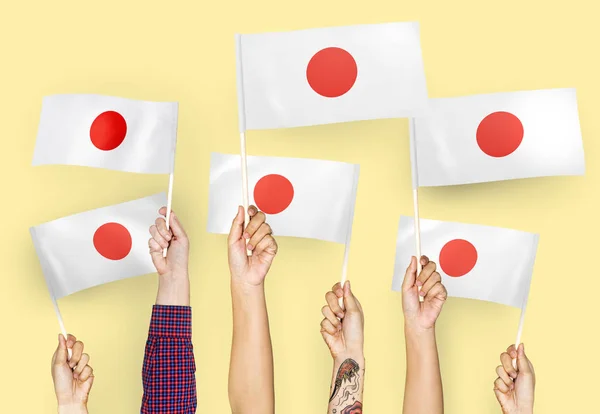 Mãos Agitando Bandeiras Japão — Fotografia de Stock