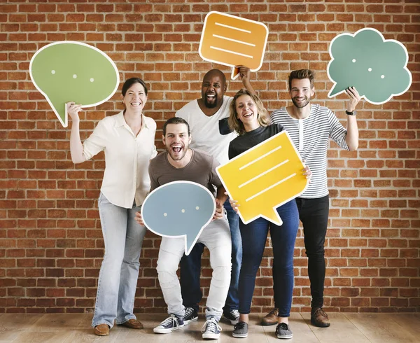 Diverse happy people holding speech bubble icons