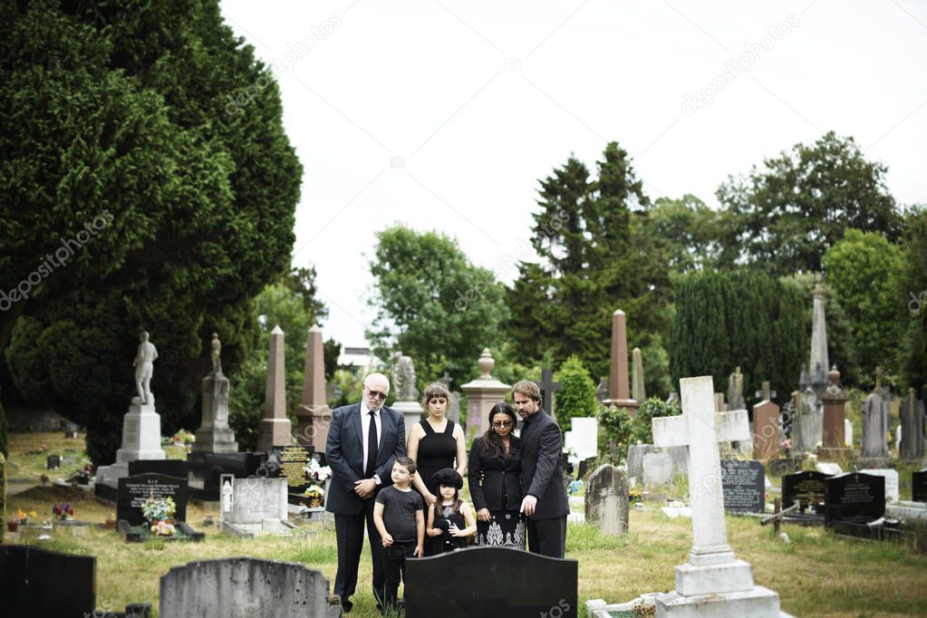 Family giving their last goodbyes at the cemetery