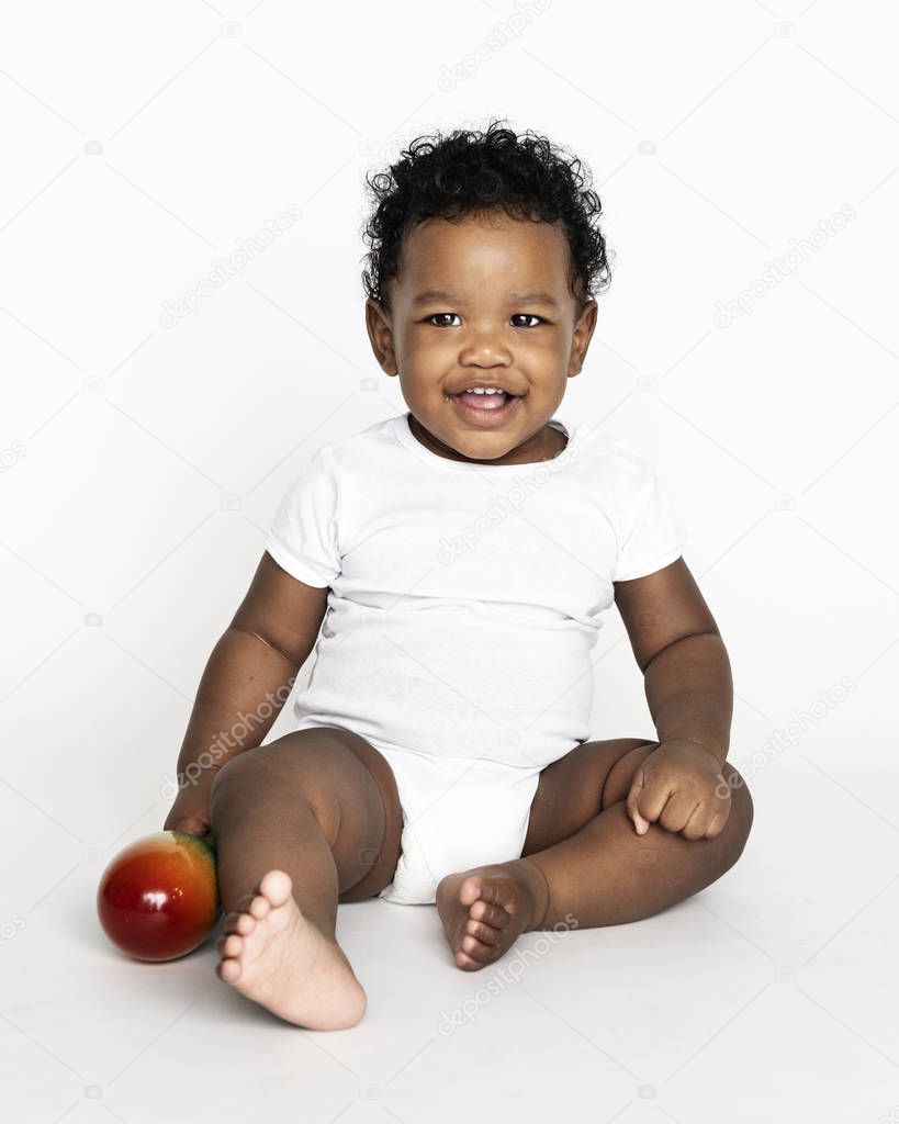 Baby sitting on the floor in a studio