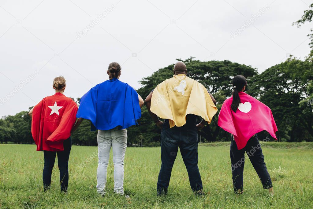 Superheroes standing in the park
