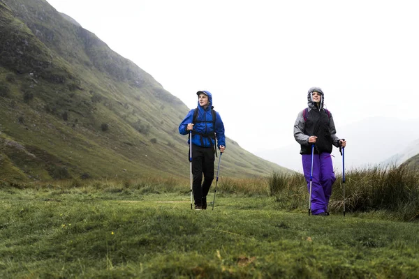 Hikers walking with trekking poles