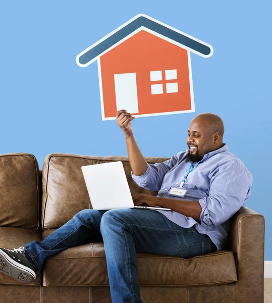 Man Showing House Icon Couch — Stock Photo, Image