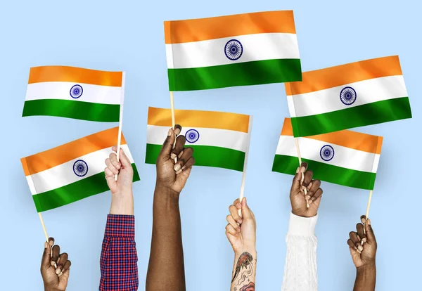Hands waving flags of India