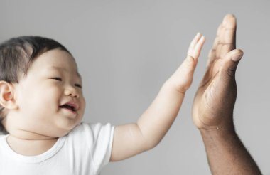 Baby giving a high five clipart