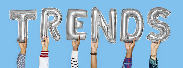 Silver alphabet helium balloons forming the text trends