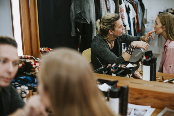 Model sitting down for her makeup