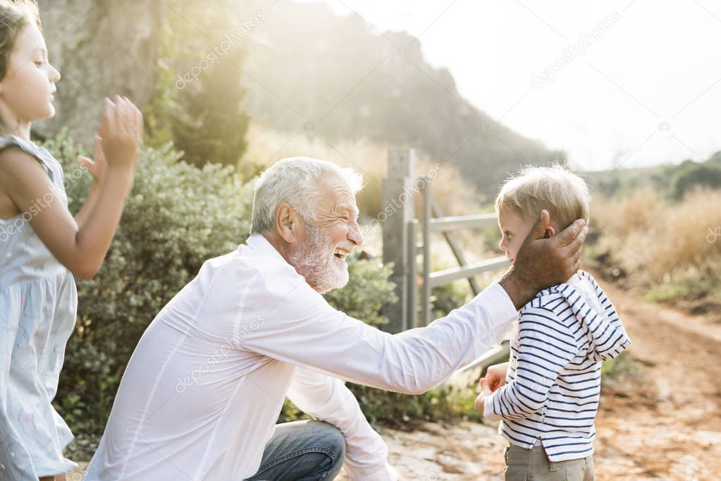 Grandfather and grandson playing outdoors