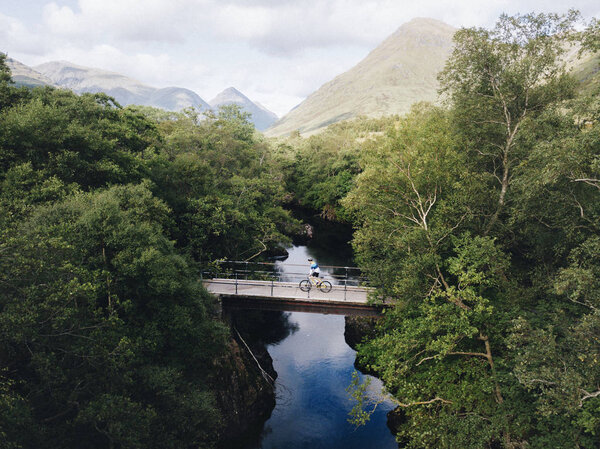 Cyclist biking over a bridge