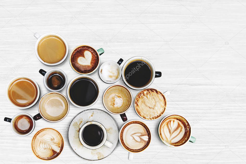 Assorted coffee cups on a textured background