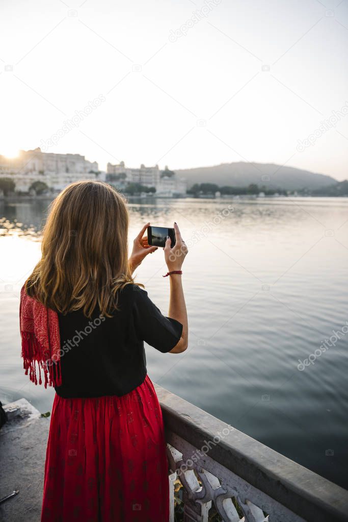 Western woman capturing the view of Udaipur city, India
