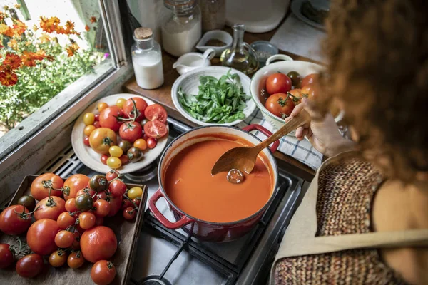 Homemade tomato soup cooking in the kitchen