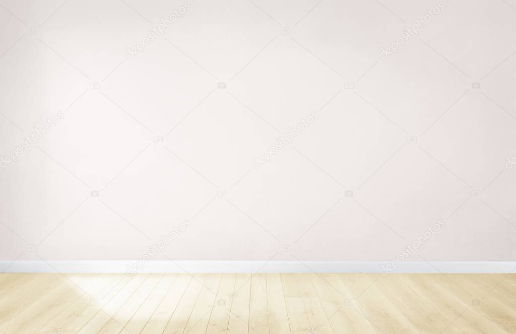 Light pink wall in an empty room with a wooden floor