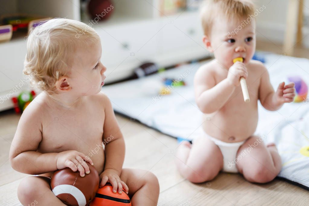 Babies in diapers playing together