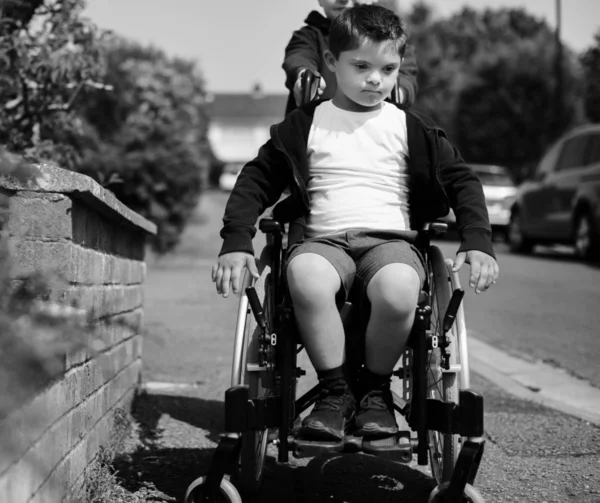 Boy Pushing His Brother Wheelchair — Stock Photo, Image