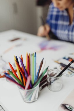 Colorful crayons in a glass
