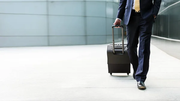 Businessman walking with his luggage