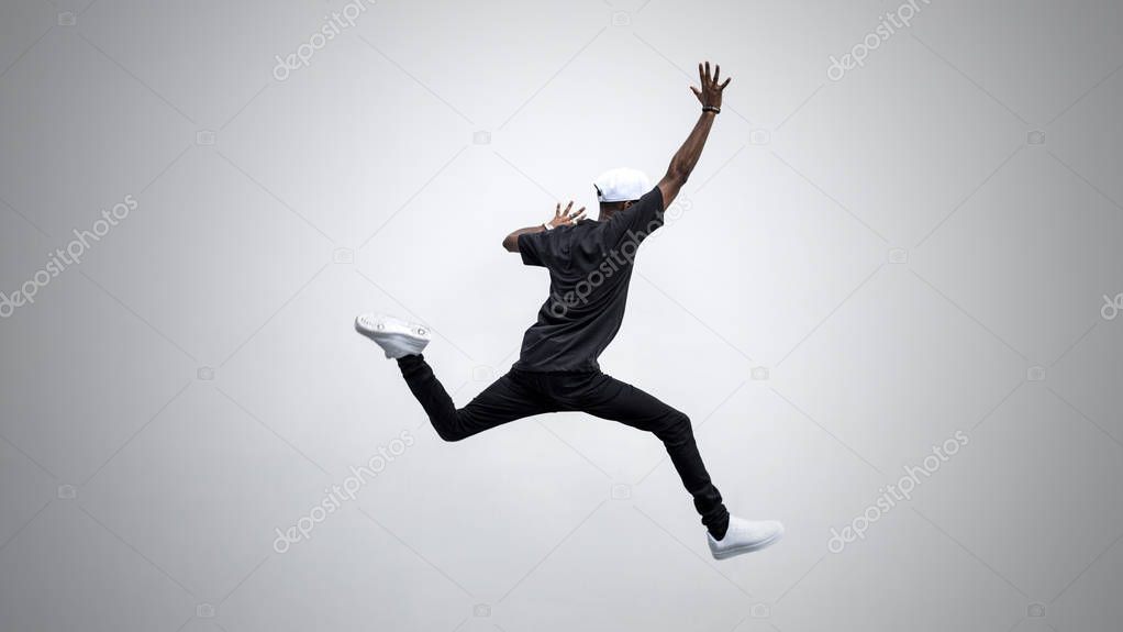 Black man jumping in to the air