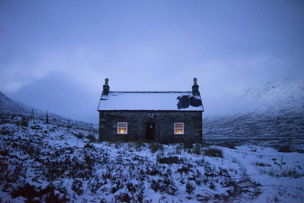 House covered with snow on a misty day