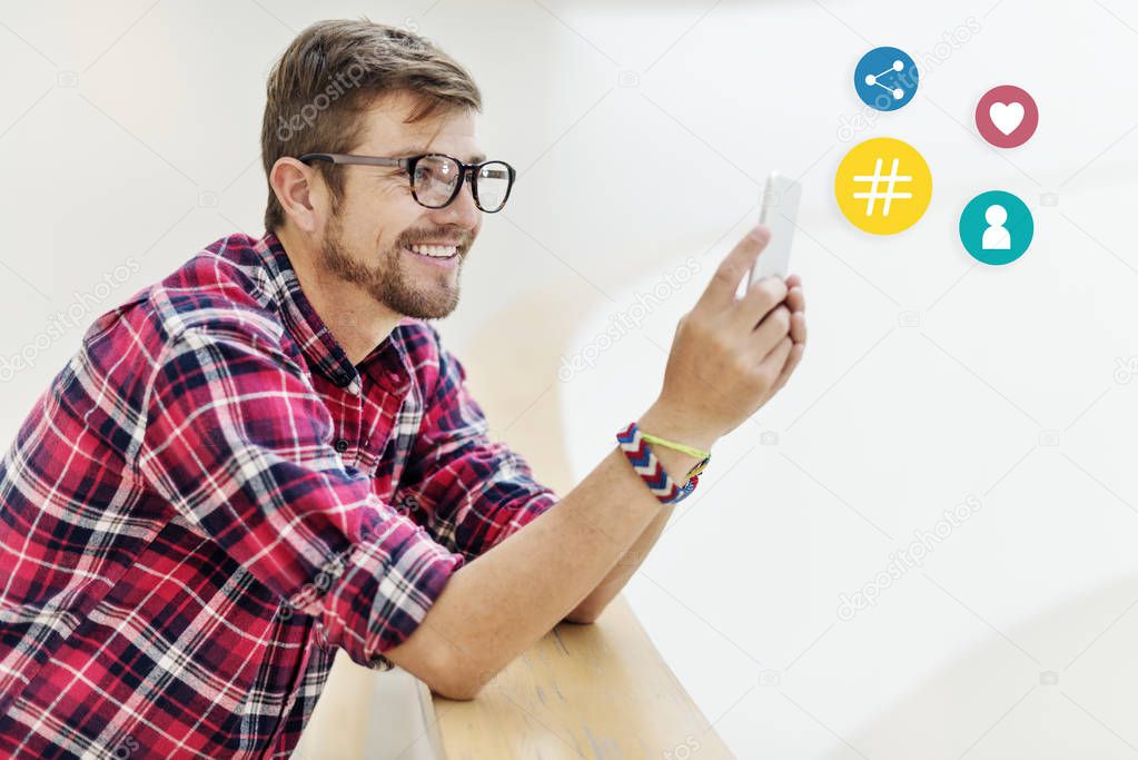 Cheerful man using his mobile phone