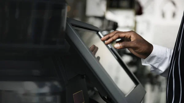 Black man working at the cashier